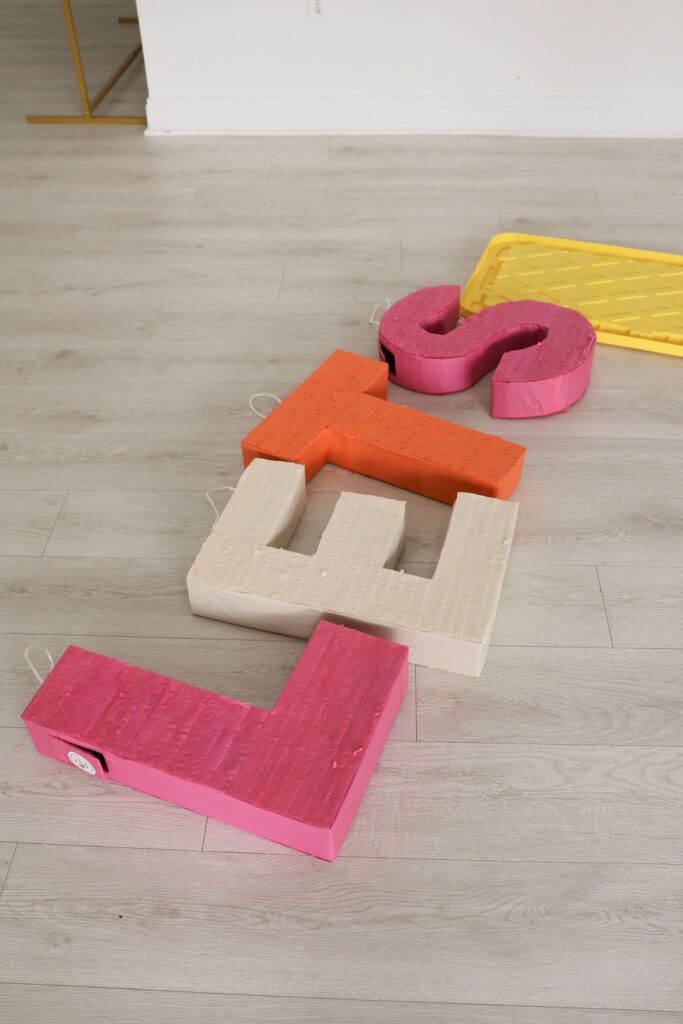 Spelling out the branded sign in pintata letters