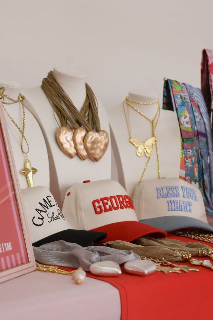 jewelry and hats for sale on a vendor's market table