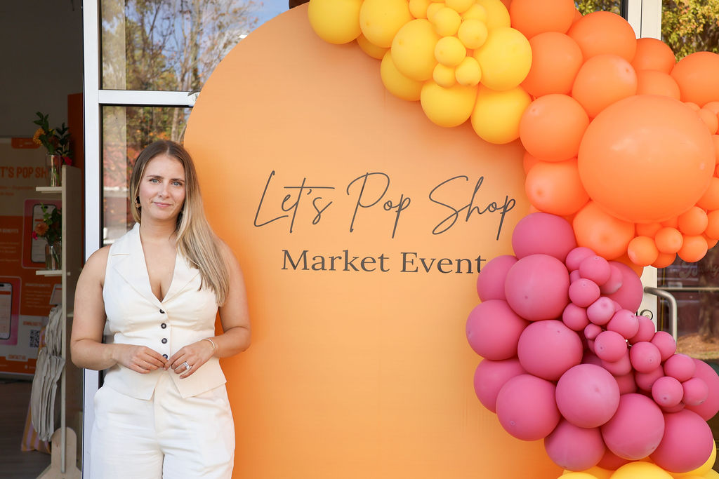 vendor posing with marketing sign